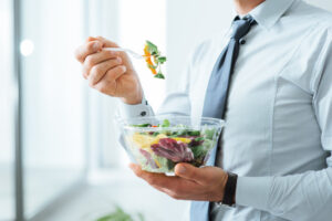 man eating a salad